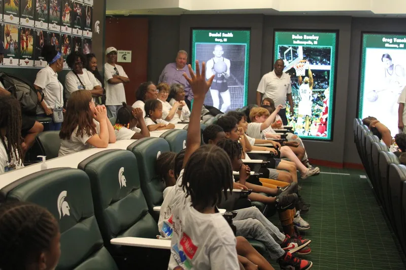 Scholars raising their hands during a Q&A session in the Spartan Hall of History